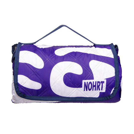 Folded NOHRT Flow blanket in travel-ready form – stylish and practical
